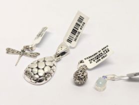 A collection of 4 silver pendants