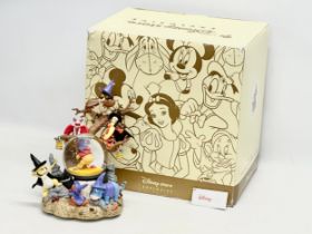 A Disney Store Exclusive ‘Winnie the Pooh’ musical snow globe with box. Snow globe measures 20x27cm.