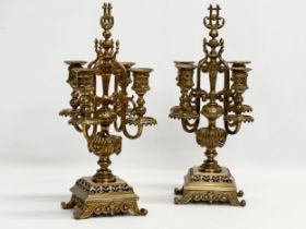 A pair of good quality early 20th century brass candelabrums with pierced bases and draped urn style