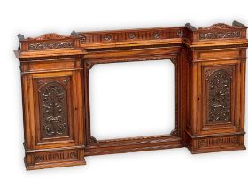 A large late Victorian carved walnut mirror back over-mantle/wall hanging cabinet. Circa 1880.