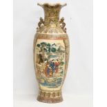 A very large Japanese style baluster pot with frilled rim, embossed painted figures and flowers.