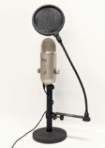 A Blue microphone, with Samson pop filter PSO1, on a Gater Frame Works stand.