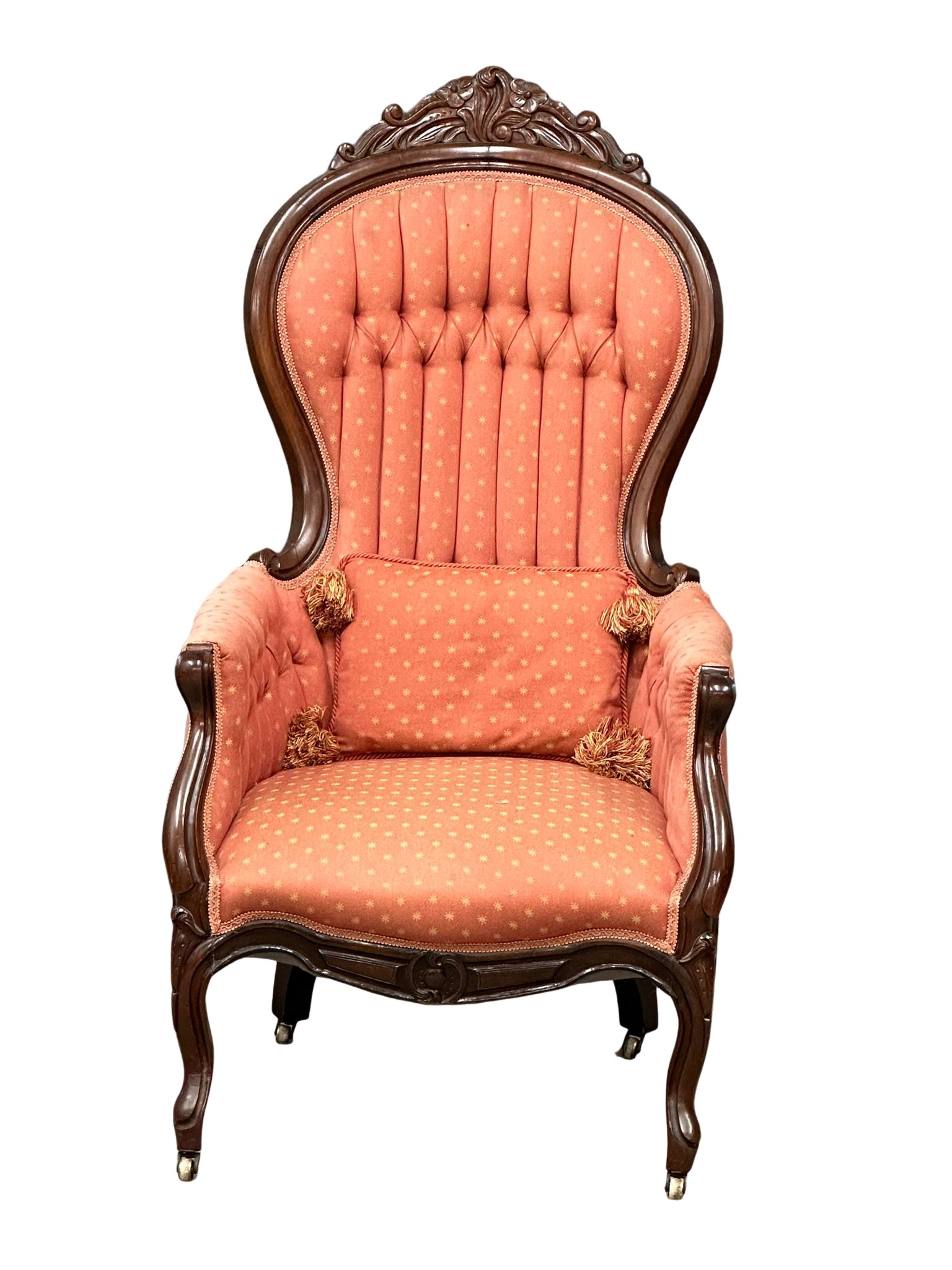 A Victorian mahogany deep buttoned back armchair on cabriole legs.