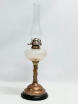 An early 20th century oil lamp with copper and brass column. 60cm