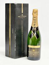 A bottle of Moet & Chandon Grand Vintage 2000 champagne with box.