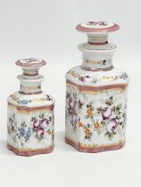 A pair of late 19th century French hand painted porcelain vanity jars/perfume bottles. Largest 14cm.