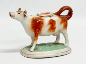 A mid 19th century Victorian Staffordshire pottery Cow Creamer. 16.5x10.5cm