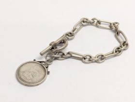 A silver 1918 George V One Shilling coin and toggle and later silver bracelet. Bracelet is London,