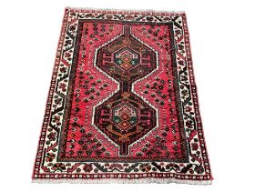 A vintage Persian Nomadic Shiraz Middle Eastern hand knotted rug. 147x100cm