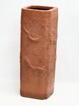 A Chinese terracotta stick stand/planter with dragon motif and Greek Key decoration. 21x21x61cm