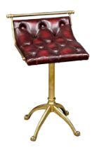 A Jans of London brass revolving harpists stool with deep button ox-blood leather seat. 39x39x60cm