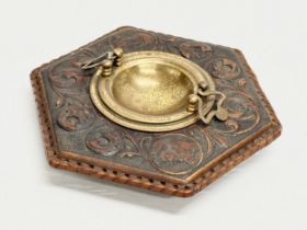 A late 19th century embossed leather bound ashtray with original brass liner. Depicting Don