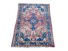 A vintage Iranian Middle Eastern hand knotted rug. 137x213cm