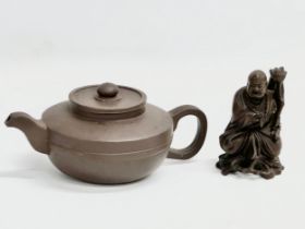 An early 20th century Chinese Yixing teapot and a small figure.