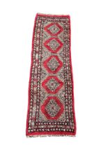 A vintage Middle Eastern hand knotted runner/rug. 70x235cm