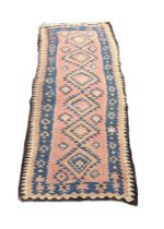 A large Middle Eastern style rug. 270x133cm