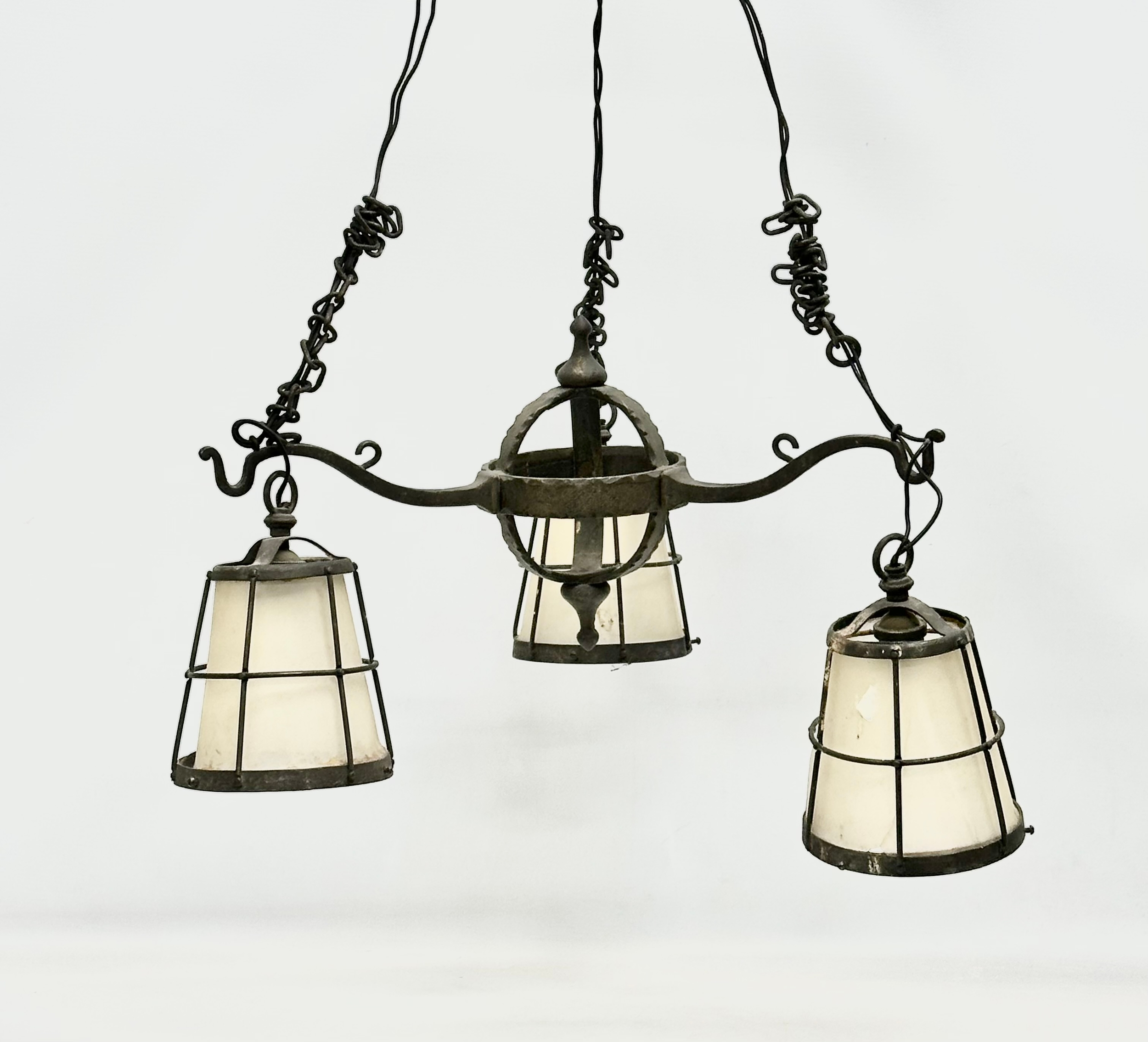 An early 20th century Arts & Crafts Wrought Iron chandelier.