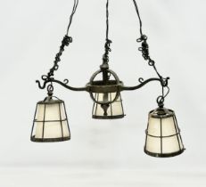 An early 20th century Arts & Crafts Wrought Iron chandelier.