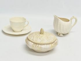 3 pieces of 4th period Belleek Pottery. A ‘Neptune’ cream jug 13x10.5cm. A ‘Tridacna’ cup and