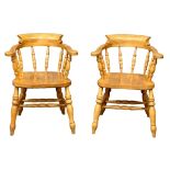 A pair of Victorian style solid beech smokers chairs/armchairs.