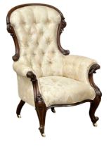 A large Victorian Mahogany deep buttoned back gents armchair on cabriole legs. Circa 1860