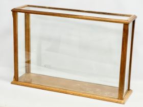 A large early 20th century oak framed display case. 85x25x56cm