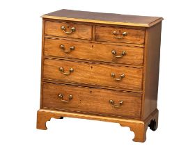 A fine proportioned George III mahogany chest of drawers with original brass drop handles and