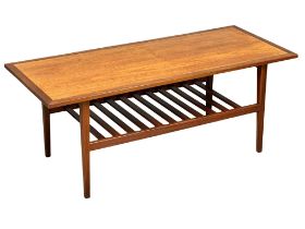 A Mid Century teak 2 tier coffee table. 122x51x48cm(2)