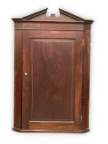 A George III inlaid mahogany wall hanging corner cabinet with 3 fitted shelves. Circa 1800.