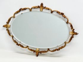 A mid 20th century gilt framed bevelled mirror. 68x48cm