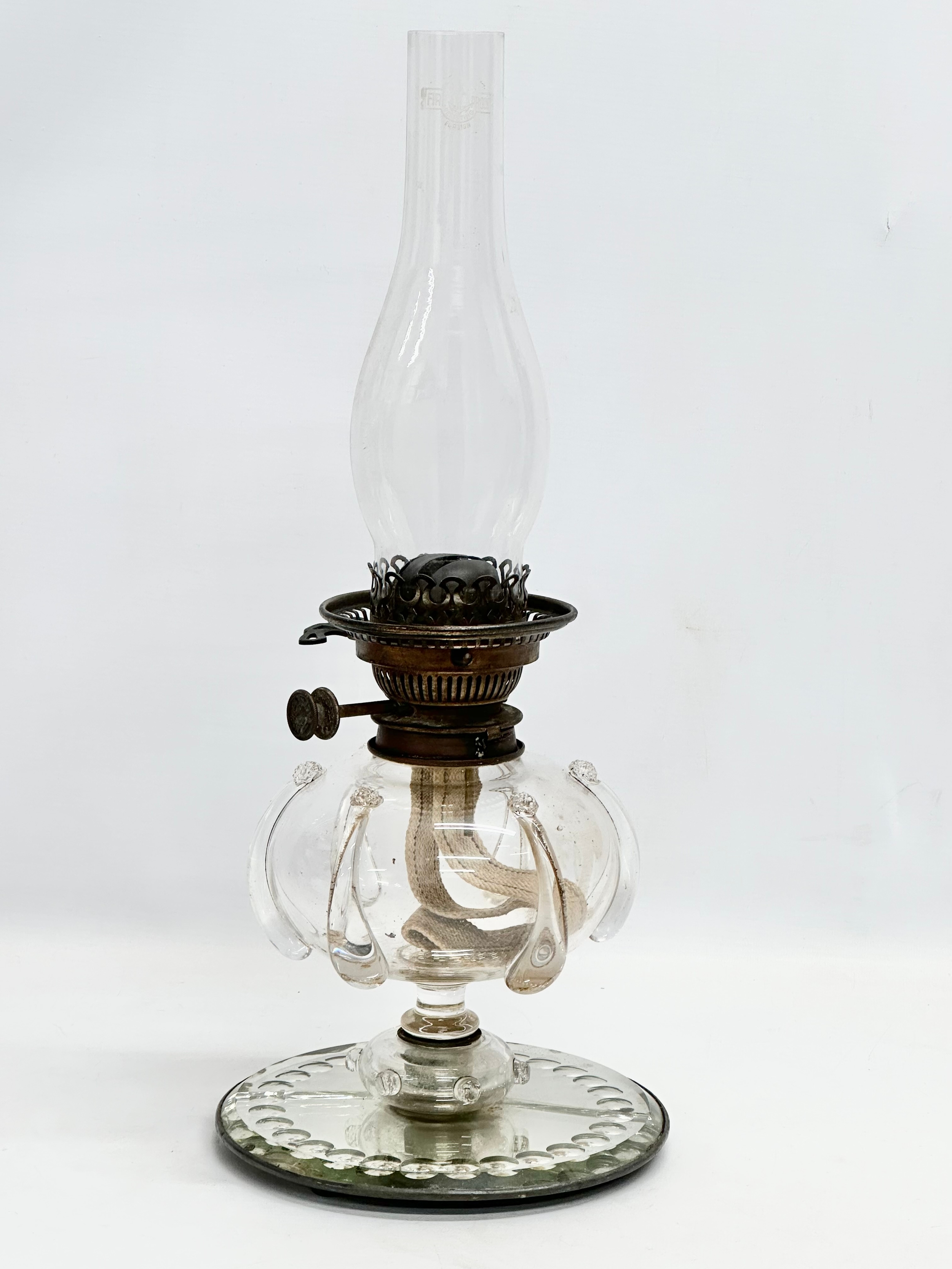 A Victorian hand blown glass bowl oil lamp on sorcerers mirror base. 20x49cm