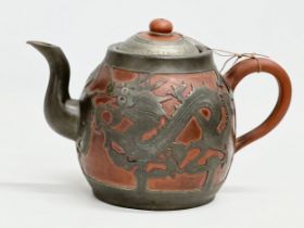 A Chinese “Sunshine Chang” pewter bound terracotta teapot, with dragon design. 20x14cm