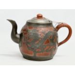 A Chinese “Sunshine Chang” pewter bound terracotta teapot, with dragon design. 20x14cm