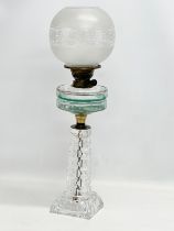 A large Victorian oil lamp with glass column, bowl and etched glass shade. 66cm