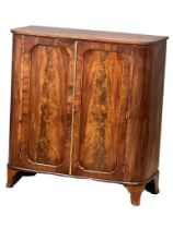 An early 19th century George III mahogany double door side cabinet/linen cupboard with fitted