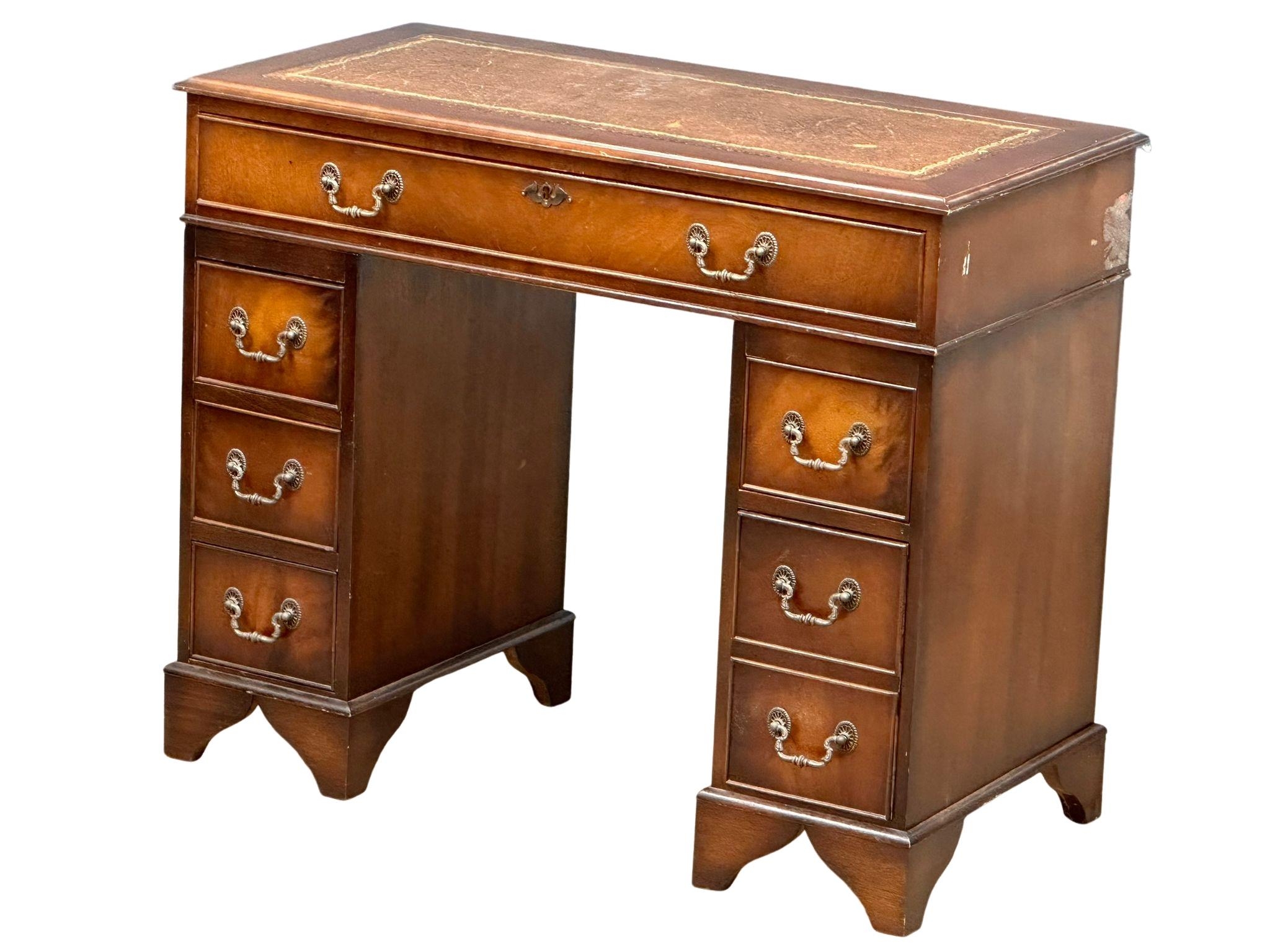 A small proportioned Georgian style mahogany pedestal desk with leather top, 91.5cm x 46cm x 76cm