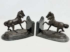 A pair of bronze bookends on marble bases signed Barrie. 23x10x18cm