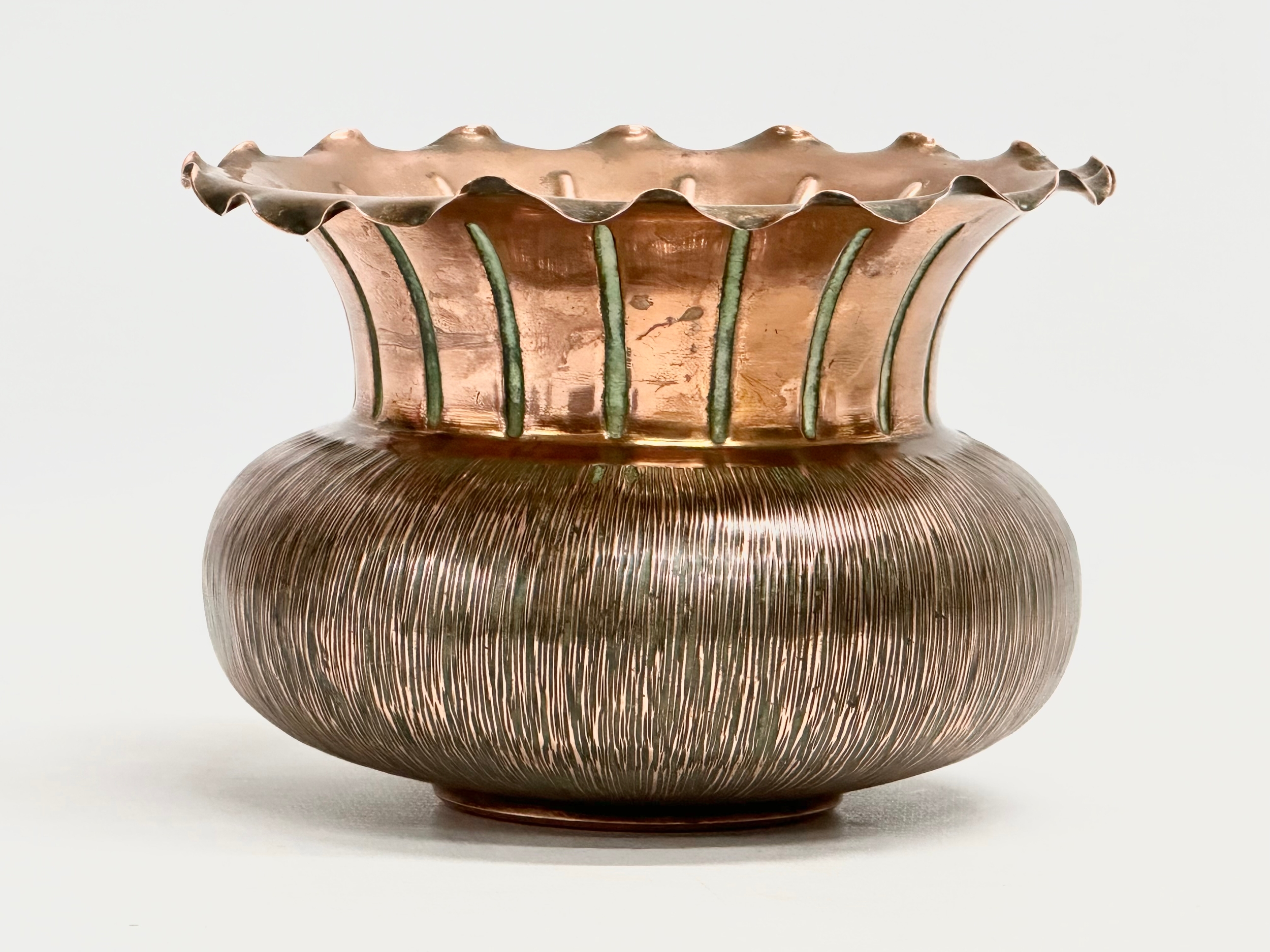 Christopher Dresser. An early 20th century copper jardiniere designed by Christopher Dresser for