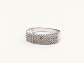 A 9k white gold and diamond ring. 5.17g. Size UK R.