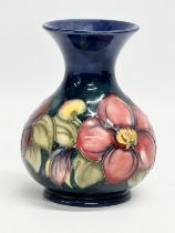 A signed Moorcroft ‘Clematis’ pottery vase. 9.5x12.5cm