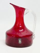 A Ruby Glass jug designed by Geoffrey Baxter for Whitefriars. 12x17cm