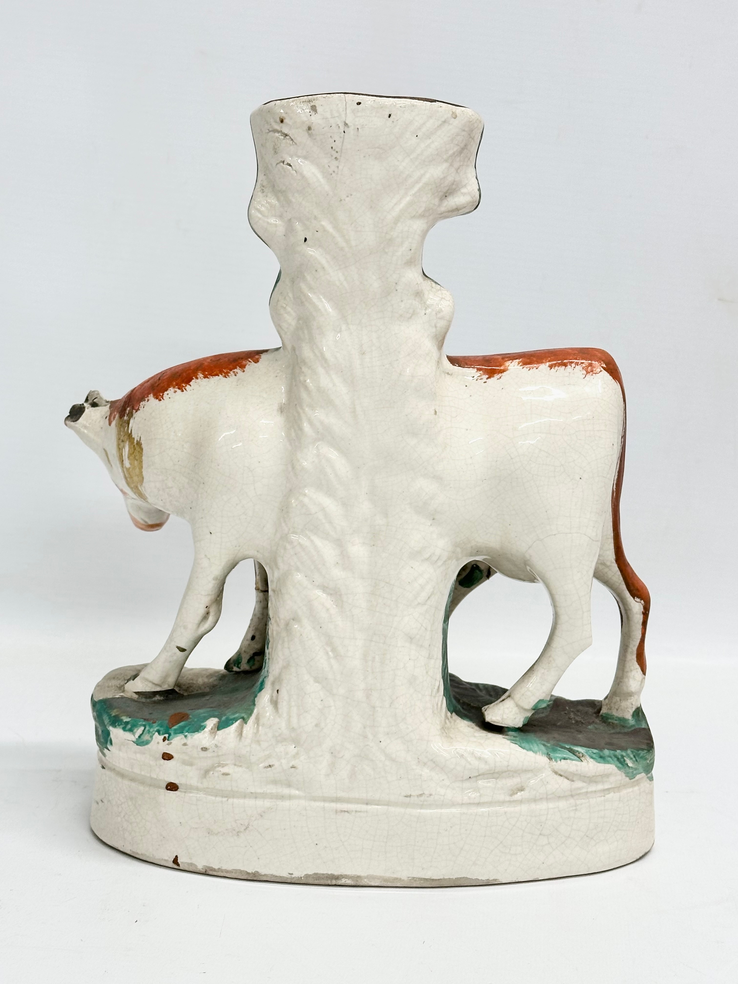 A pair of mid/late 19th century Staffordshire Cow spill vases. 22x27.5cm - Image 7 of 7
