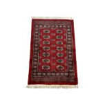 A vintage hand knotted Turkoman Afghan rug. 100x166cm