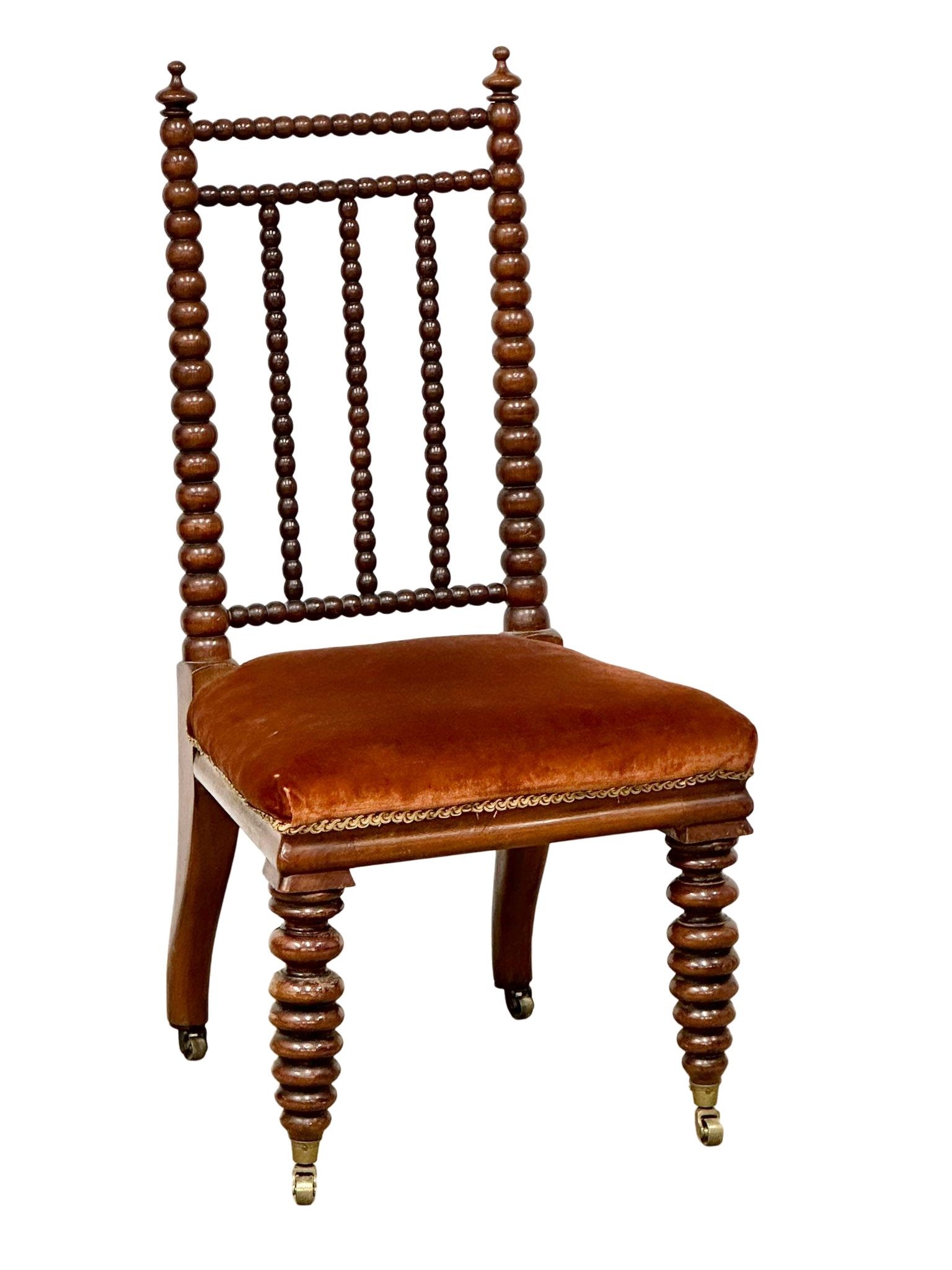 A Victorian walnut Bobbin Turn side chair on brass cup casters, circa 1850-70s.