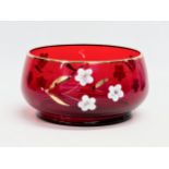 A mid 20th century Bohemian Ruby Glass fruit bowl with embossed painted flower and gilt rim. 17x9cm