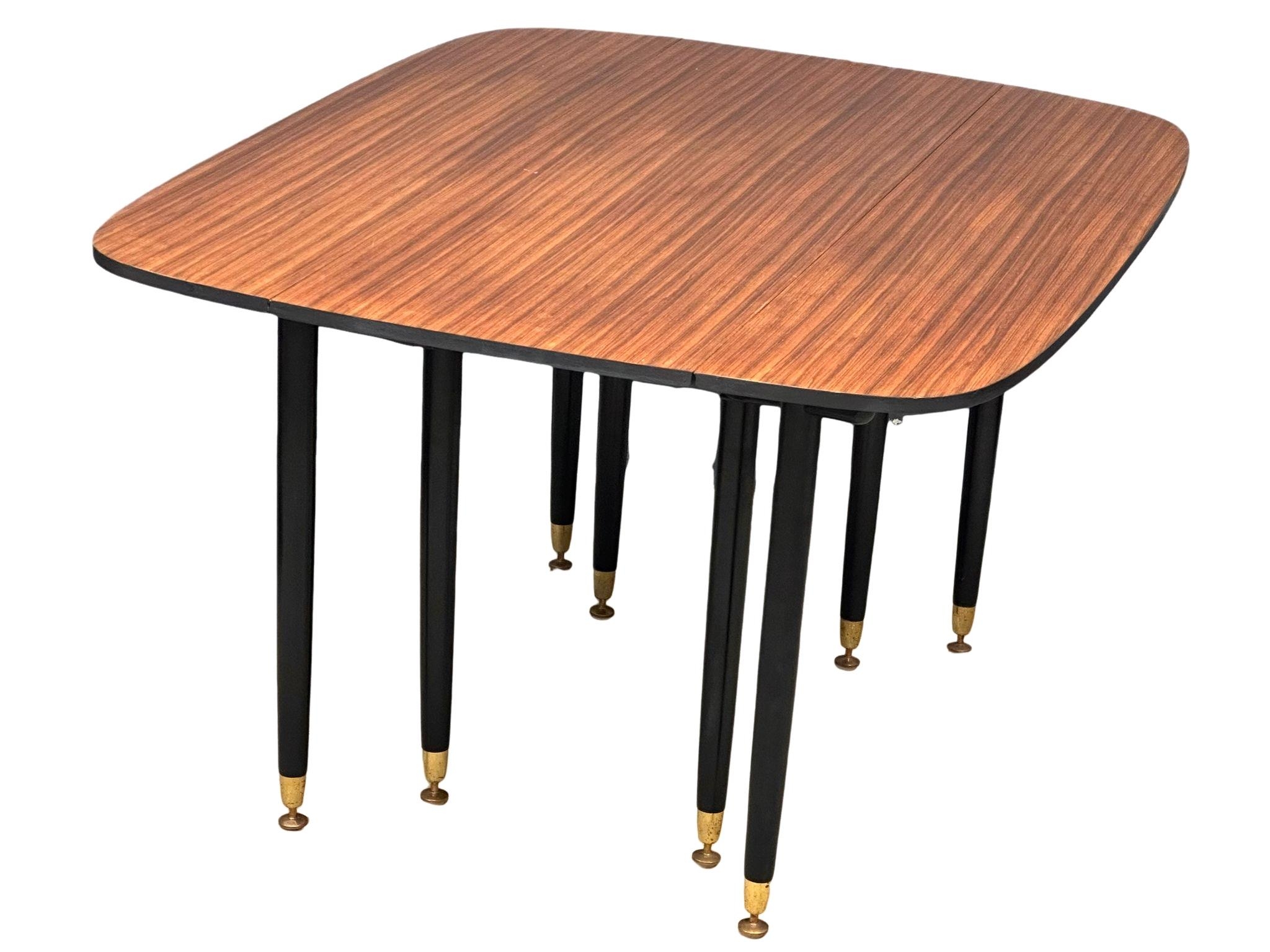 A large G-Plan "Librenza" tola wood drop-leaf dining table, circa 1950-60. 133cm x 107cm x 72cm