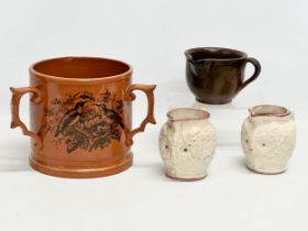 A collection of 19th and early 20th century pottery. A large early 20th century Loving Cup, a pair