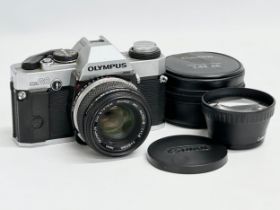 A vintage Olympus OM20 camera and a Canon lens with case.