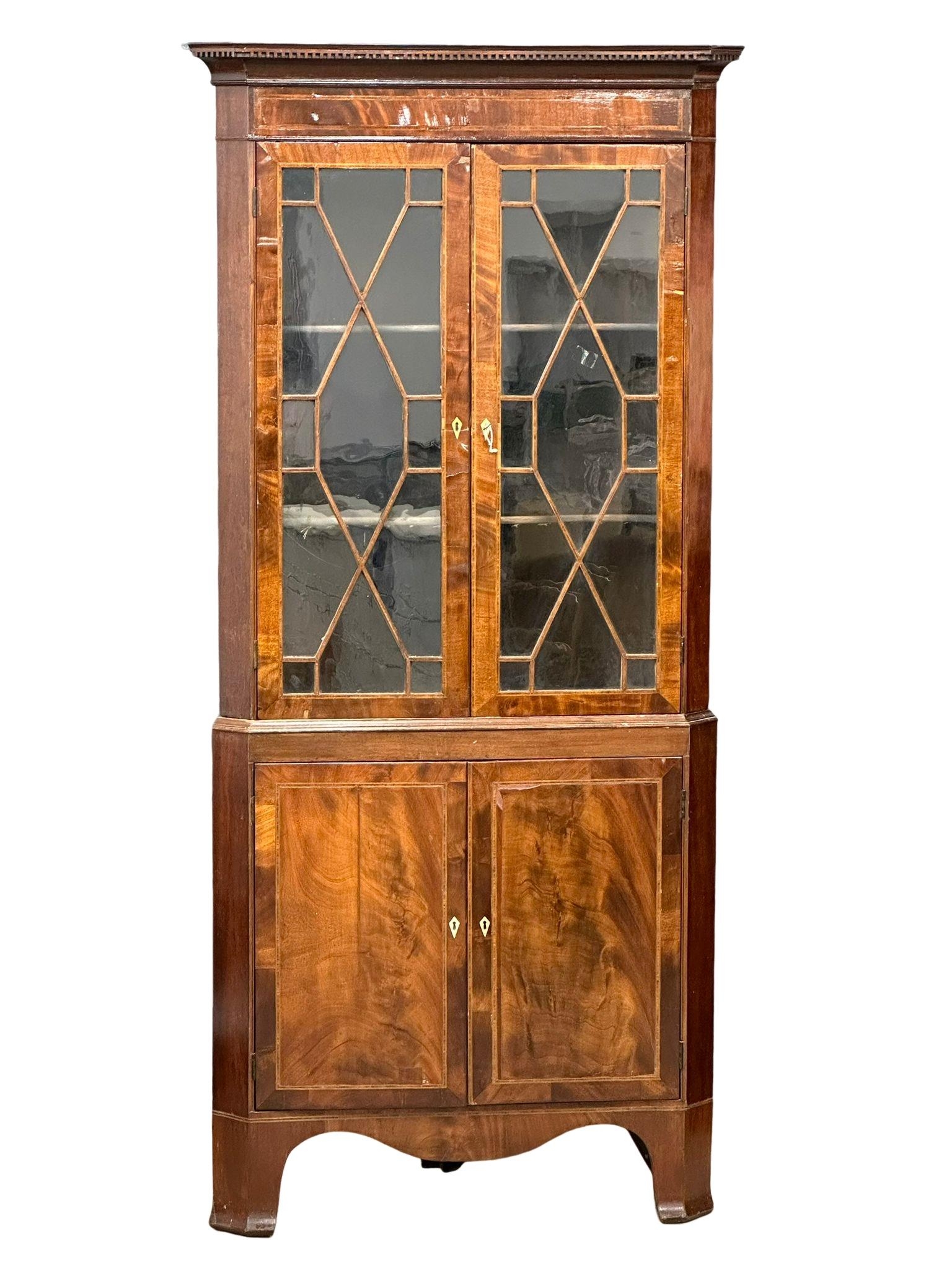 A George III inlaid mahogany corner display cabinet with astragal glazed doors. Circa 1800.