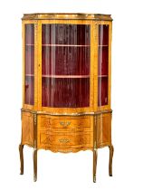 A French 18th century style inlaid kingwood vitrine/display cabinet with double bowed glass, brass